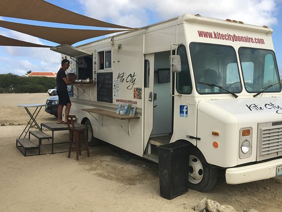 Een afbeelding van de Kitecity foodtruck op te amo beach bonaire.