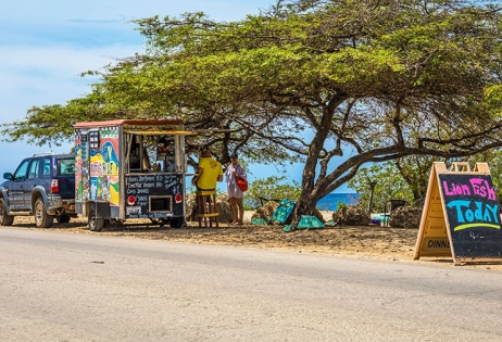 An image of a foodtruck under a divi divi tree at donkey beach bonaire.